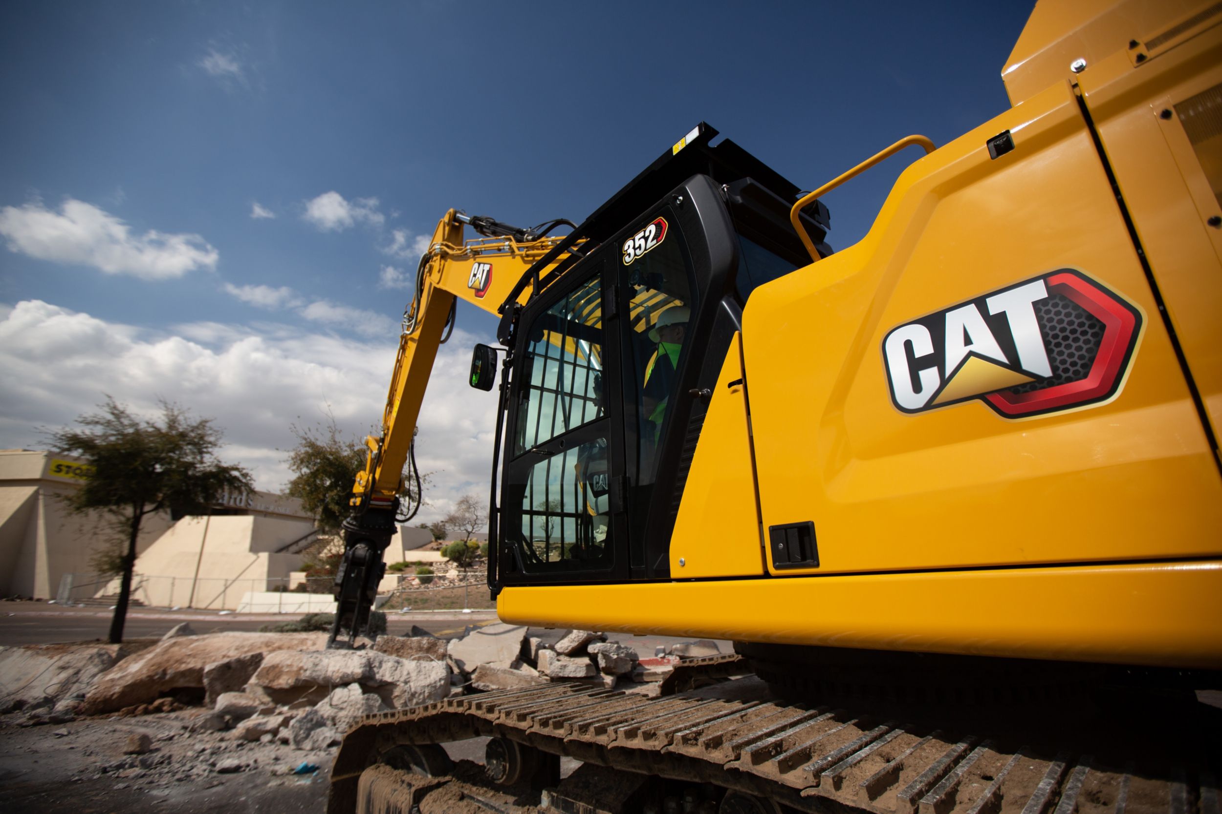 A Cat® 352 Excavator is pulverizing concrete with a multi-processor attachment.