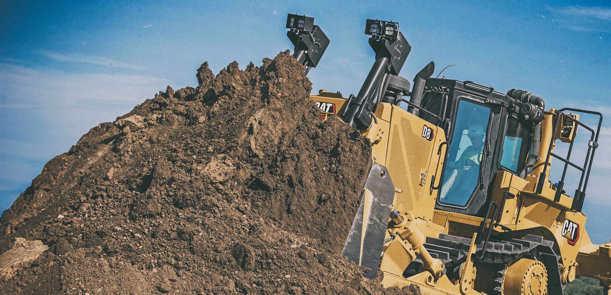Cat D8 Dozer pushing dirt with sky in the background