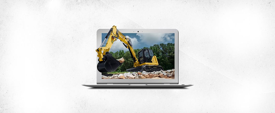 Miniexcavadora saliendo de la pantalla de una computadora