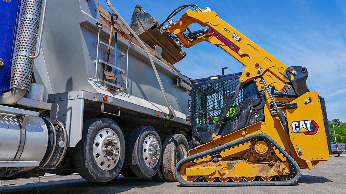Skid Steer Loader loading into a truck