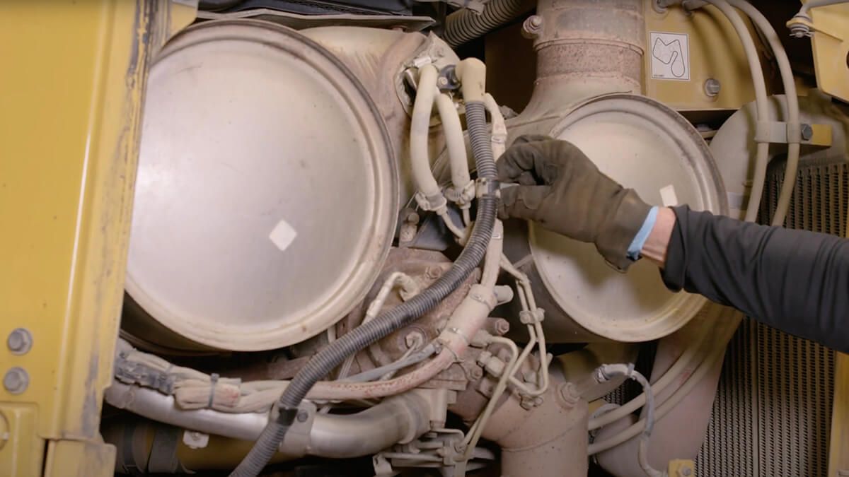 worker inspecting and repairing a machine