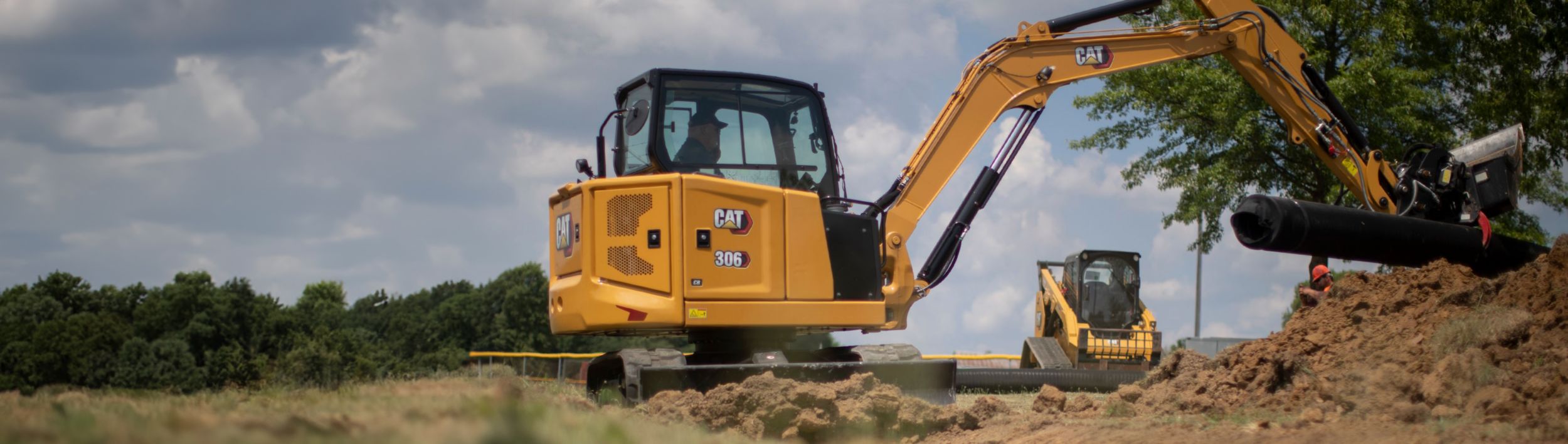 306 mini excavator with compact track loader in background