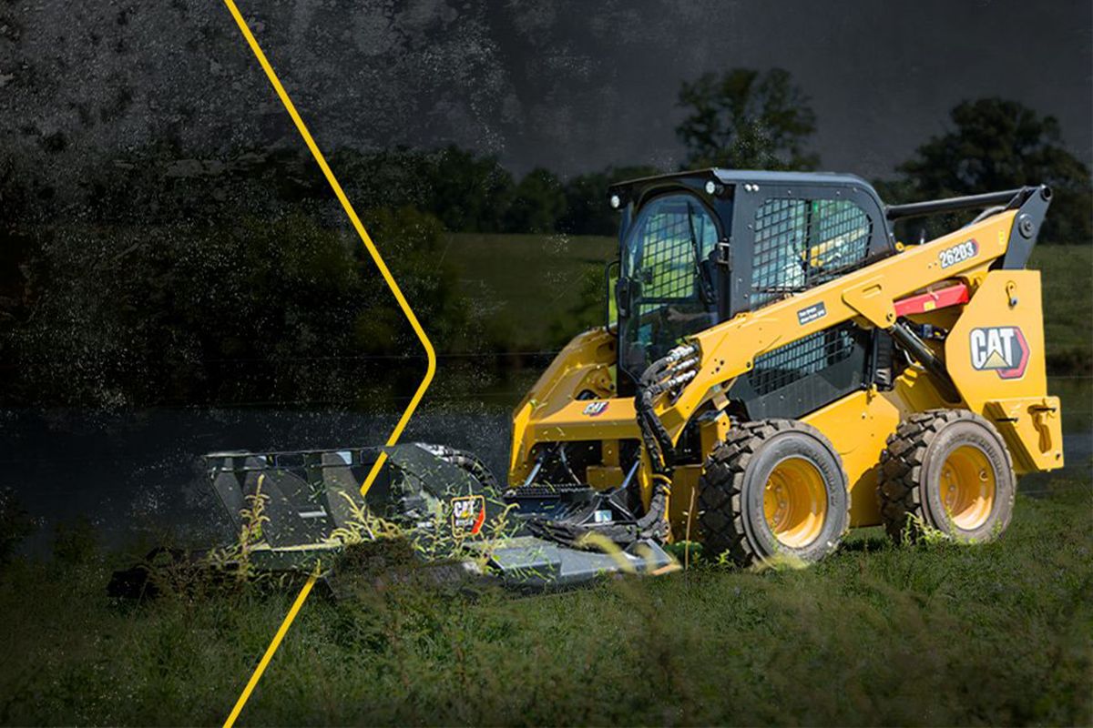 Cat track loader in grass field with arrow graphic