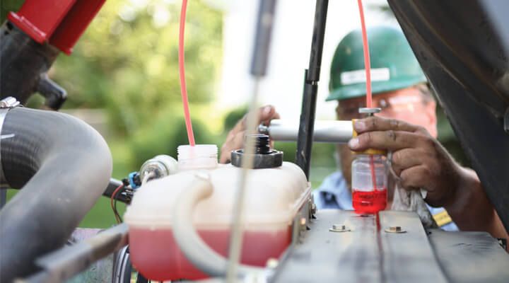 Technician taking oil sample