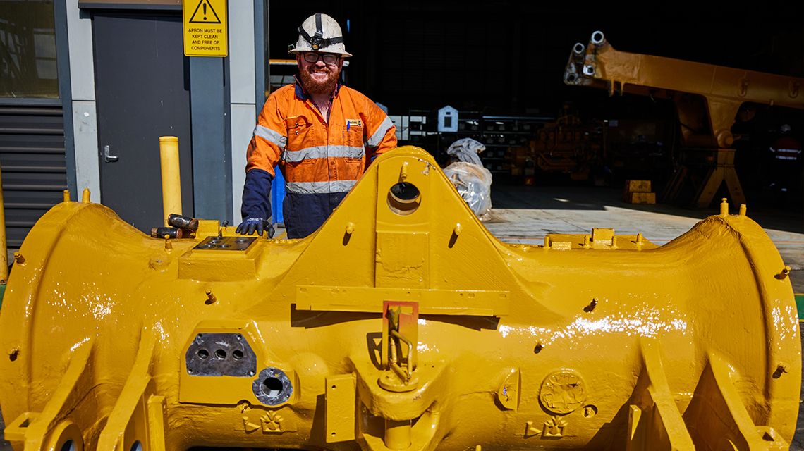Person standing behind Cat engine