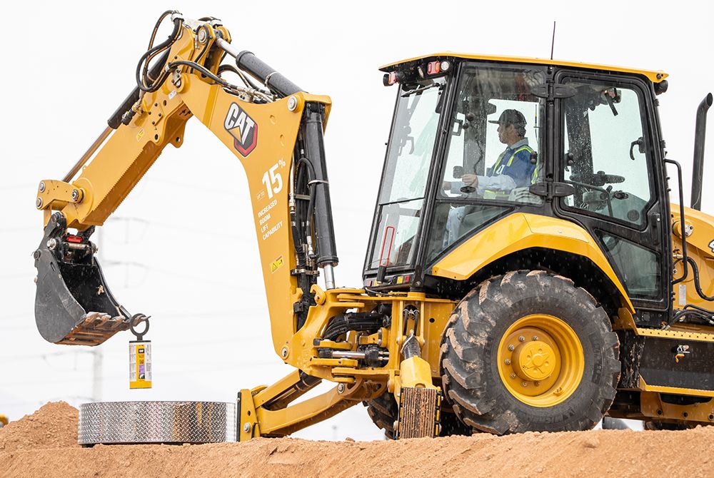 Backhoe lifting weight with bucket